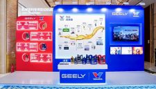 A display booth featuring Valvoline GEELY collaboration, showcasing co-developed lubricants and a timeline of their partnership, with product bottles arranged on a central table.