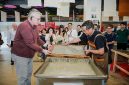 H.E. Mr. Karlis Eihenbaums，ambassador of Latvia to China, tries his hand at the traditional craft of Xuan papermaking.